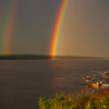 A photo of a Double Rainbow with two water planes, Mackenzie River, Fort Simpson June 2025