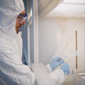 Clean Suite Researcher at a Fume Hood