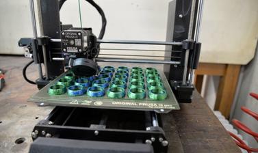 3D Printer printing blue globe shapes