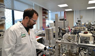 Lab Manager operating machinery in the noble gas lab
