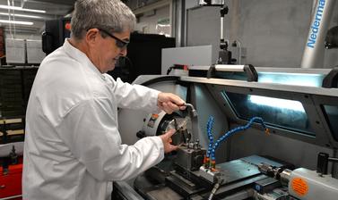 Workshop technician operating a lathe