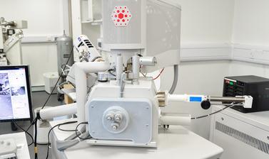 The image shows the FEI Quanta 650 Scanning Electron Microscope in the Earth Sciences Department Lab E-Beam Suite.