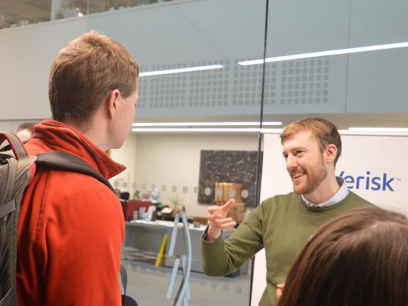 Photograph of an alumnus speaking to an undergraduate at the careers fair.