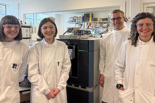 Authors of the Study Group photograph of study authors standing in a lab wearing lab coats and safety gear. They are smiling at the camera
