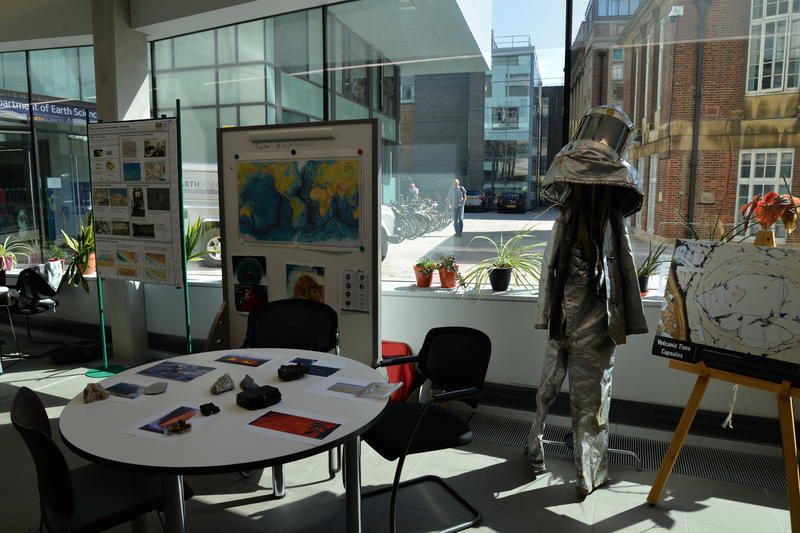 A display of volcanology equipment at an Open Day A display of volcanology equipment at an Open Day. The equipment includes a volcanologist suit and a table of samples. The display is situated in front of some large glass windows.