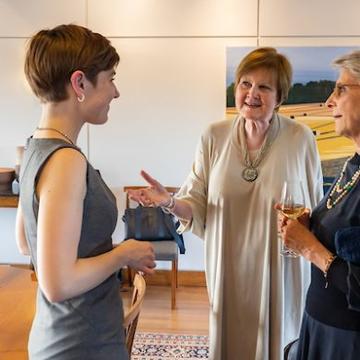 Photograph of Ally talking to another person at a conference