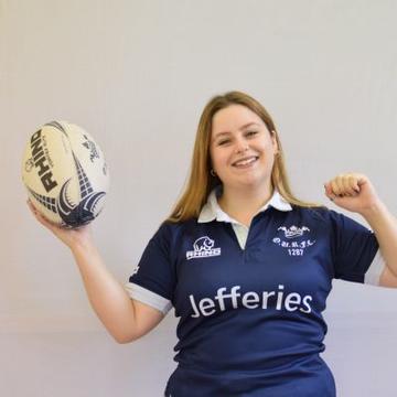 Lucy headshot Player headshot of Lucy Jackson, smiling and holding a rugby ball