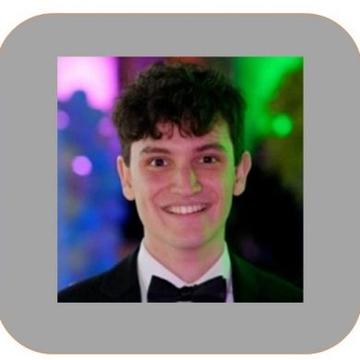 A headshot of Evan Pryce wearing a suit and bow tie
