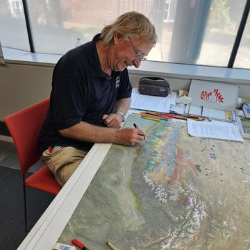 Mike Searle Edits the Eastern Sheet of the Map of the Himalayas Professor Mike Searle making some additions to the eastern sheet