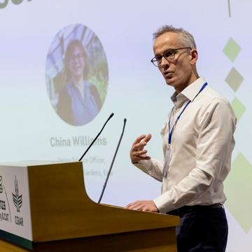 Gideon Henderson speaking at a podium