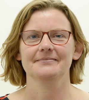 Passport style photograph of Elisabeth Crabbe. She is wearing glasses and has short blonde hair.