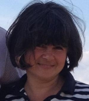 Head and shoulders photograph of Maria Petrunova. She has dark hair cut into a bob with a fringe and is wearing a striped shirt.